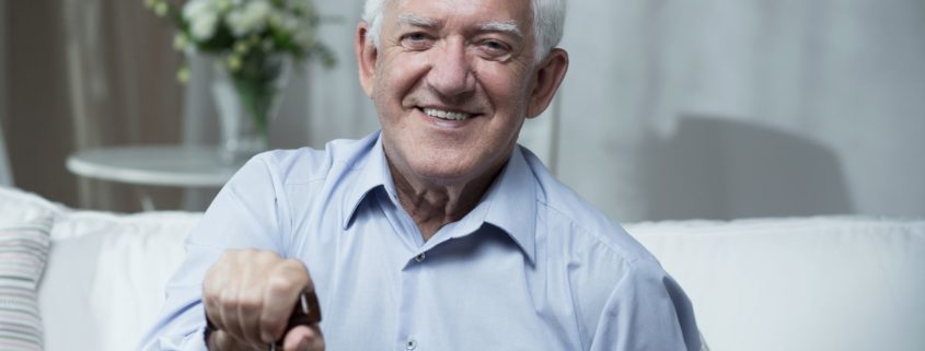 smiling older man with cane