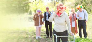 Happy disabled senior woman celebrating Birthday in park